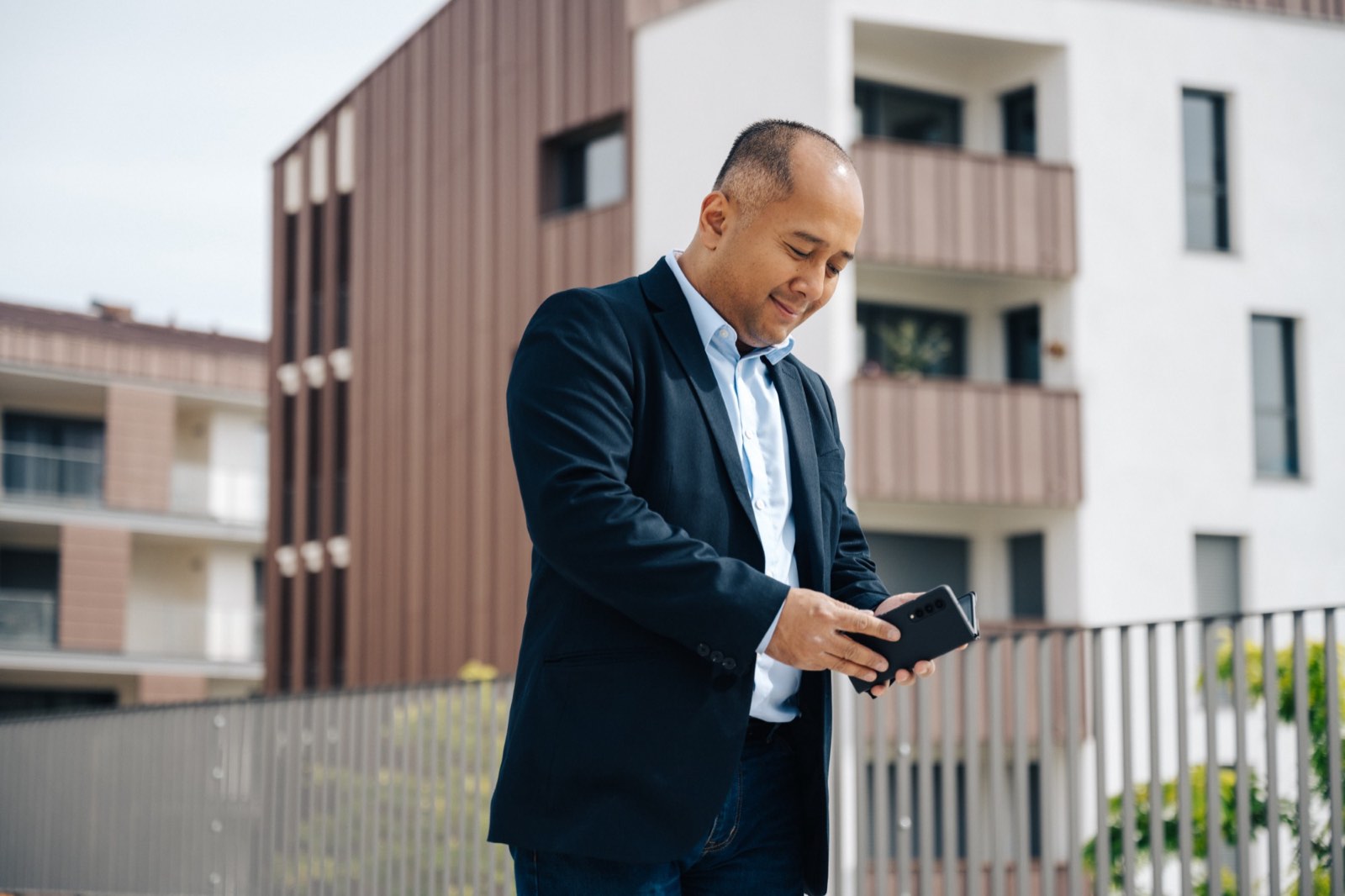 Chan Ing, fondateur de Visual Apps, consultant son smartphone en extérieur